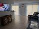 Living room featuring tile flooring, large window and sliding door, and comfortable seating at 335 N Causeway # E3, New Smyrna Beach, FL 32169
