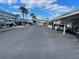 Wide view of the parking lot, showcasing ample parking space with covered parking available at 335 N Causeway # E3, New Smyrna Beach, FL 32169
