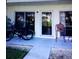 Patio featuring a sliding glass door, a chair, and two bicycles in front of the unit at 335 N Causeway # E3, New Smyrna Beach, FL 32169