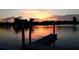 Scenic waterfront view featuring a wooden dock under a colorful sunset sky at 335 N Causeway # E3, New Smyrna Beach, FL 32169