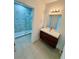A sleek bathroom vanity complemented by modern lighting, showcasing a minimalist style at 1314 Congo Ct, Poinciana, FL 34759