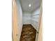 Walk-in closet with wood flooring and white walls equipped with sturdy wire shelving at 1314 Congo Ct, Poinciana, FL 34759