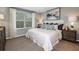 Relaxing bedroom with a comfortable bed, elegant lamps, and soft natural light through the window at 2549 Penguin Blvd, Davenport, FL 33837