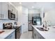 Modern kitchen design with stainless steel appliances, gray cabinetry, and countertops for stylish meal preparation at 2549 Penguin Blvd, Davenport, FL 33837