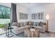 Cozy living room featuring a neutral sectional, decorative pillows, and a rustic-chic coffee table atop a patterned rug at 2549 Penguin Blvd, Davenport, FL 33837