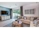 Inviting living room with a comfortable sofa, a decorative coffee table, and a view of the outdoor patio at 2549 Penguin Blvd, Davenport, FL 33837