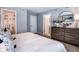 Calm main bedroom featuring a dresser, ensuite bathroom, and walk-in closet for extra storage space at 2549 Penguin Blvd, Davenport, FL 33837