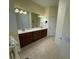 Bathroom featuring a double sink vanity with granite counters, tile flooring and lots of light at 3345 Tesoro Cir, New Smyrna Beach, FL 32168