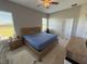 Spacious bedroom featuring hardwood floors, natural light, and a rustic wooden bed adding warmth and character at 3345 Tesoro Cir, New Smyrna Beach, FL 32168