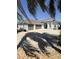 Beautiful single-story home boasts a three-car garage and manicured front yard with tropical landscaping at 3345 Tesoro Cir, New Smyrna Beach, FL 32168