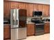 Modern kitchen featuring stainless steel appliances, granite countertops, and ample cabinet space at 3345 Tesoro Cir, New Smyrna Beach, FL 32168
