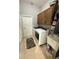 Functional laundry room features modern appliances, built-in cabinets, and utility sink, offering convenience and ample storage at 3345 Tesoro Cir, New Smyrna Beach, FL 32168