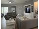 Cozy living room with tile floors features a entertainment center and comfortable seating at 3345 Tesoro Cir, New Smyrna Beach, FL 32168