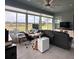 The sunroom has lots of windows, a ceiling fan, a leather sofa and a wood desk with office equipment at 3345 Tesoro Cir, New Smyrna Beach, FL 32168