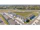 A high-angle aerial view shows the community layout, featuring townhomes, parking, and green spaces at 6677 Sw 81St Loop, Ocala, FL 34476