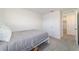 This bedroom features a white bed, door, and window at 6677 Sw 81St Loop, Ocala, FL 34476