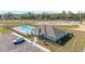 Community pool with a covered area, lounge seating, and manicured landscaping at 6677 Sw 81St Loop, Ocala, FL 34476