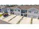 Charming townhomes featuring attached garages and landscaped front yards at 6677 Sw 81St Loop, Ocala, FL 34476