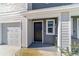 Close-up of a home's front entrance and garage, highlighting the clean design and landscaping at 6677 Sw 81St Loop, Ocala, FL 34476