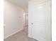 Upstairs hallway with carpet and multiple doors at 6677 Sw 81St Loop, Ocala, FL 34476