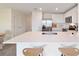 Kitchen island with a sink, white countertops, and seating, perfect for casual dining at 6677 Sw 81St Loop, Ocala, FL 34476