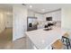 Bright kitchen featuring white cabinets, stainless steel appliances, and a peninsula with bar seating at 6677 Sw 81St Loop, Ocala, FL 34476