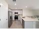 Spacious kitchen features white cabinets, stainless steel appliances, and ample counter space at 6677 Sw 81St Loop, Ocala, FL 34476