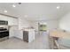 Well-lit open floor plan with modern kitchen flowing into a comfortable living area at 6677 Sw 81St Loop, Ocala, FL 34476