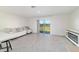 Bright living room with sliding glass doors to the outside and neutral decor at 6677 Sw 81St Loop, Ocala, FL 34476
