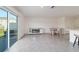 Open-concept area with living, dining, and kitchen spaces, brightened by natural light from the patio at 6677 Sw 81St Loop, Ocala, FL 34476