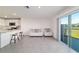 Open layout integrating kitchen and living space, featuring modern finishes and outdoor access at 6677 Sw 81St Loop, Ocala, FL 34476