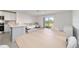Open concept layout showcasing the kitchen, living, and dining area with cohesive design at 6677 Sw 81St Loop, Ocala, FL 34476