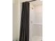 Close-up of shower with black and white striped curtain at 6677 Sw 81St Loop, Ocala, FL 34476