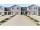 Charming exterior view of newly constructed townhomes each with a single-car garage at 6677 Sw 81St Loop, Ocala, FL 34476