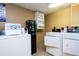 Clean laundry room featuring modern washing machines and dryers at 7601 Canada Ave # 623, Orlando, FL 32819