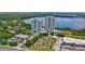 Wide aerial view of condo towers and lake, showcasing nearby shopping and a miniature golf course at 13415 Blue Heron Beach Dr # 1407, Orlando, FL 32821