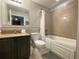 Well-lit bathroom showcasing a vanity, toilet, and bathtub with shower and tile surround at 13415 Blue Heron Beach Dr # 1407, Orlando, FL 32821
