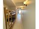 Hallway featuring a bunk bed on the left and a view of the living room and balcony in the distance at 13415 Blue Heron Beach Dr # 1407, Orlando, FL 32821