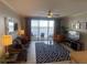 Cozy living room featuring a comfortable sofa and a view to the balcony with chairs at 13415 Blue Heron Beach Dr # 1407, Orlando, FL 32821