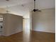 Spacious living room with gleaming hardwood floors, ceiling fans, and ample natural light from the sliding glass door at 636 Birgham Pl, Lake Mary, FL 32746