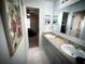 Bathroom with double sinks, large vanity, and view to bedroom with carpet flooring at 9233 Tom Moore Rd, Lakeland, FL 33810