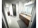 Bathroom featuring double vanity sinks, tile floors, and a walk-in shower at 9233 Tom Moore Rd, Lakeland, FL 33810