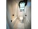 Bathroom with a shower and a window with decorative plants at 9233 Tom Moore Rd, Lakeland, FL 33810