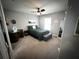 This bedroom has carpet flooring, a ceiling fan and a window at 9233 Tom Moore Rd, Lakeland, FL 33810
