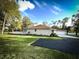 Charming home with a well-maintained lawn, white picket fence, and an attached two-car garage at 9233 Tom Moore Rd, Lakeland, FL 33810