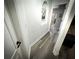Hallway with laminated flooring, art niche, and white trim around the door frames at 9233 Tom Moore Rd, Lakeland, FL 33810