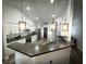 Bright kitchen with stainless steel appliances, white cabinets, and modern pendant lighting at 9233 Tom Moore Rd, Lakeland, FL 33810