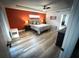 Bedroom features tray ceilings, ceiling fan, and ensuite bathroom entrance at 9233 Tom Moore Rd, Lakeland, FL 33810