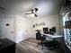 Home office featuring laminated flooring, a ceiling fan, and a workspace at 9233 Tom Moore Rd, Lakeland, FL 33810