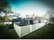 Backyard view of a screened-in pool with white picket fence, landscaping, and a well-maintained lawn at 9233 Tom Moore Rd, Lakeland, FL 33810
